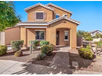 Two-story tan house with landscaped yard, walkway, and driveway at 2090 S Moccasin Trl, Gilbert, AZ 85295