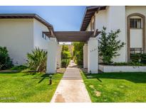 Inviting front gate and walkway leading to the property, with manicured lawn and landscaping at 3637 E Monterosa St # 17, Phoenix, AZ 85018