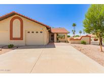Charming single-story home with a well-maintained lawn and a two-car garage in a quiet neighborhood at 542 S Higley Rd # 99, Mesa, AZ 85206