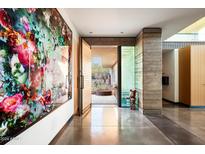 Bright entryway with large-scale art and view to a courtyard at 5555 N Camino Del Contento --, Paradise Valley, AZ 85253