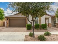 Charming single-story home featuring a two-car garage and manicured landscaping at 10065 E Thatcher Ave, Mesa, AZ 85212