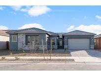 Single-story home with gray exterior, brick accents, and a two-car garage at 22531 E Orchard Ln, Queen Creek, AZ 85142