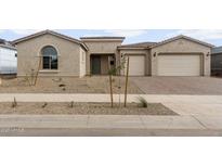 Stunning single-story home features a two-car garage and low maintenance desert landscaping in front at 22631 E San Tan Blvd, Queen Creek, AZ 85142