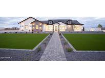 Stunning single-story home with a manicured lawn, stone accents, and a welcoming walkway at 3888 E Weston Ln, San Tan Valley, AZ 85140