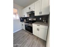 Modern kitchen with white shaker cabinets, stainless steel appliances, and gray countertops at 311 W Pontiac Dr # 8, Phoenix, AZ 85027