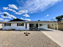 Charming single-story home featuring a covered carport and low-maintenance desert landscaping at 2213 E Janice Way, Phoenix, AZ 85022