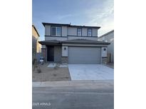 Two-story house with gray siding, a two-car garage, and landscaping at 2593 E Bluff Spring Ave, Apache Junction, AZ 85119