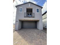 Gray two-story home showcasing a spacious two-car garage and a charming balcony at 2445 W Rowel Rd, Phoenix, AZ 85085