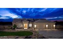 Stunning single-story home with a three-car garage and desert landscaping set against a striking twilight sky at 300 W Quartz Rock Rd, Phoenix, AZ 85085