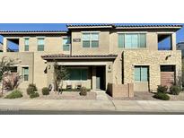 Two-story townhome with stone accents and a landscaped front yard at 746 E Doral Ave # 201, Gilbert, AZ 85297
