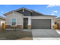 Charming single-story home with a two-car garage and stylish stone accents on the facade at 16555 N Lunar St, Maricopa, AZ 85138