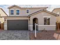 Charming two-story home with a well-maintained front yard and two car garage at 11624 W Beck Dr, Youngtown, AZ 85363