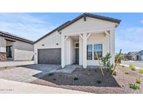Charming single-story home featuring a grey roof, well-manicured yard and stylish modern farmhouse architecture at 4405 N 203Rd Ave, Buckeye, AZ 85396