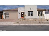 Modern home exterior with stone accents and a two-car garage at 876 W Golden Ore Pass, Apache Junction, AZ 85120
