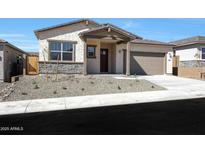 Charming single-story home featuring a desert landscaped yard and a covered front porch at 28266 N 134Th Dr, Peoria, AZ 85383