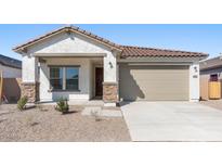 Charming single-story home featuring a tile roof, stone accents, and a two-car garage at 16610 N Dante Way, Maricopa, AZ 85138