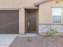 New construction home with attractive stone accents and a two-car garage at 9145 N 173Rd Ln, Waddell, AZ 85355