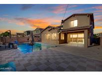Inviting backyard pool and spa, set in a stone paver patio, is perfect for outdoor entertaining at 4102 S 186Th Ave, Goodyear, AZ 85338