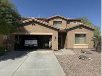 Two-story house with attached garage and desert landscaping at 45194 W Miramar Rd, Maricopa, AZ 85139