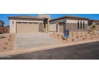 Charming home with a modern exterior, stone accents, well-kept yard, and a spacious two-car garage at 23978 S 218Th Pl, Queen Creek, AZ 85142
