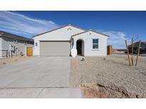 Charming single-story home featuring a neutral color palette and a two-car garage at 40000 W Bravo Dr, Maricopa, AZ 85138