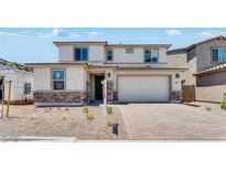 Two-story home with neutral paint, stone accents, brick driveway, and a two-car garage at 3804 S Buttercup --, Mesa, AZ 85212