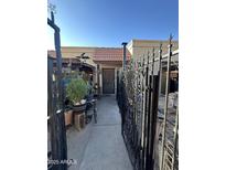 Home exterior with gated entry and walkway at 211 E Loma Linda Blvd # 2, Avondale, AZ 85323