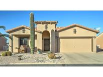Charming single-story home featuring desert landscaping, a two-car garage, and a welcoming front entrance at 2101 S Meridian Rd # 131, Apache Junction, AZ 85120