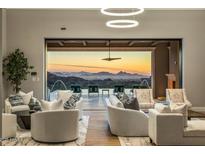 Spacious living room features stunning sunset views and access to the pool area at 10739 E Diamond Rim Dr, Scottsdale, AZ 85255
