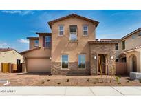 Charming two-story home featuring stucco and stone accents and a paved driveway at 5851 S Romano --, Mesa, AZ 85212