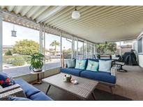 Relaxing screened patio with wicker furniture and view of backyard at 10714 W Willowbrook Dr, Sun City, AZ 85373