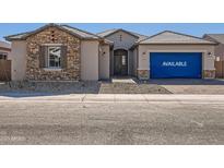 Beautiful single-story home featuring stone accents, a tiled roof, and a covered porch at 25153 N 177Th Dr, Surprise, AZ 85387