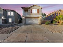 Charming two-story home with a large driveway and a small second story balcony at 14862 W Laurel Ln, Surprise, AZ 85379