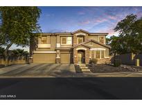 Charming two-story home featuring a stone facade, covered entryway, and a well-manicured front yard at 8813 S 13Th Pl, Phoenix, AZ 85042