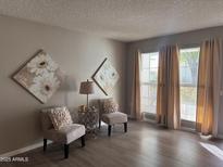 Bright living room with hardwood floors and large windows at 10606 W Granada Dr, Sun City, AZ 85373