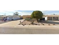 Charming single-story home with a low-maintenance desert landscape and mature tree in the front yard at 1486 S Lawther Dr, Apache Junction, AZ 85120