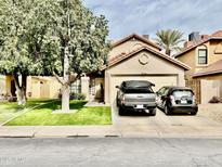 Charming single-story home with a well-manicured lawn and a two-car garage with a driveway at 4444 E Wildwood Dr, Phoenix, AZ 85048