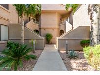 Condominium exterior with desert landscaping, multiple levels, and private entrances at 15380 N 100Th St # 1106, Scottsdale, AZ 85260