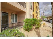 Attractive condo building with a charming patio area, desert landscaping, and convenient covered parking at 14575 W Mountain View Blvd # 11113, Surprise, AZ 85374