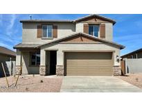 Charming two-story home with stone accents, a two-car garage, and a well-maintained front yard at 25204 W Wayland Dr, Buckeye, AZ 85326