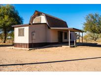 Ranch style home with a barn style roof and covered porch at 6102 S 101St Dr, Tolleson, AZ 85353