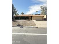 Charming single-story home featuring a well-maintained yard and attached two-car garage at 848 S Revolta Cir, Mesa, AZ 85208