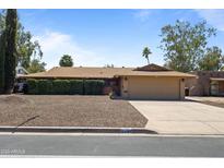 Charming single-story home features a two-car garage and neatly landscaped front yard at 848 S Revolta Cir, Mesa, AZ 85208
