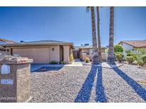 Single-story home with a two-car garage and desert landscaping at 10437 E Chestnut Dr, Sun Lakes, AZ 85248