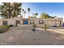 Single-story home with a desert landscaping and basketball court at 6511 E Presidio Rd, Scottsdale, AZ 85254