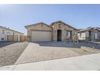 One-story home with stone accents and a paved driveway at 16367 W Morning Glory St, Goodyear, AZ 85338