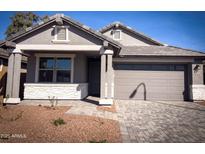 Charming single-story home featuring a neutral color palette, a two-car garage, and a well-manicured front yard at 5434 W Las Palmaritas Dr, Glendale, AZ 85302