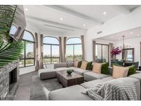 Spacious living room with large windows showcasing scenic views and a comfortable, oversized sectional at 3800 E Lincoln Dr # 23, Phoenix, AZ 85018
