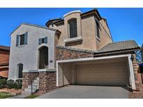 Charming two-story home featuring a stucco facade with a two-car garage and stone accents at 4232 E Tyson St, Gilbert, AZ 85295