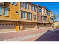Townhouse exterior with attached garages and brick driveway at 900 S 94Th St # 1065, Chandler, AZ 85224